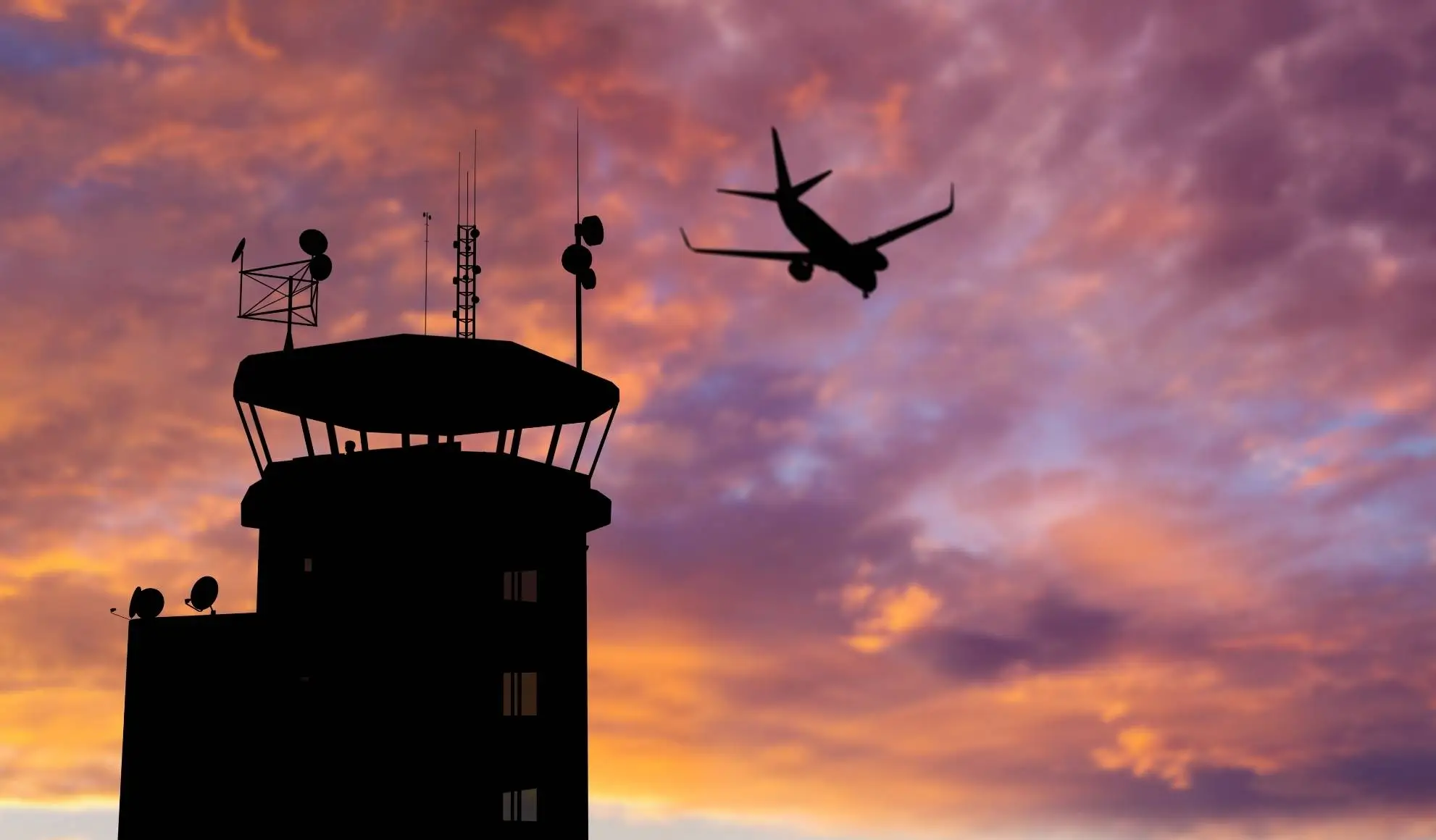 Torre di controllo aeroportuale e traffico aereo al tramonto, simbolo della complessità del sistema dei voli di linea nel 2026
