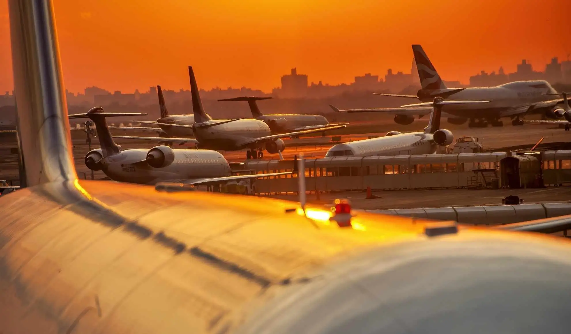 Aeromobili in sosta e in rullaggio su un aeroporto congestionato, simbolo della pressione sul sistema dei voli di linea